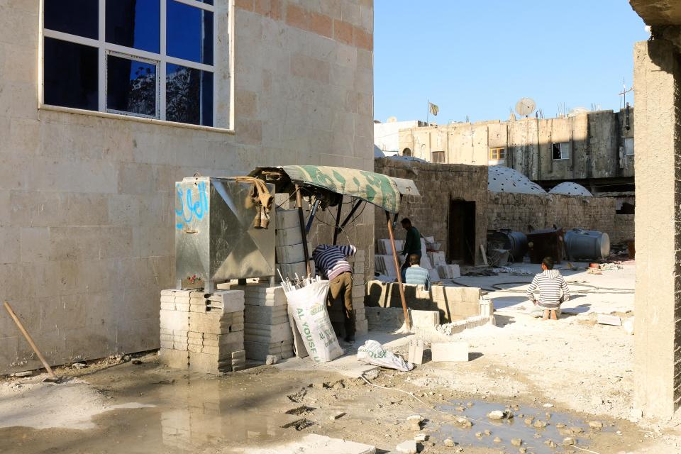  Workers trying to repair the hotel and restore it for tourists