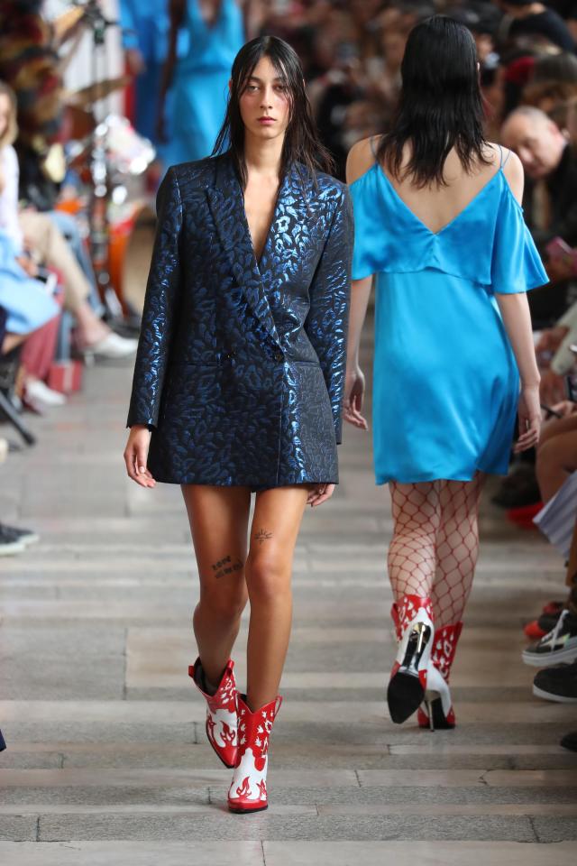  A model walks the runway in cowboy boots at Paris Fashion Week