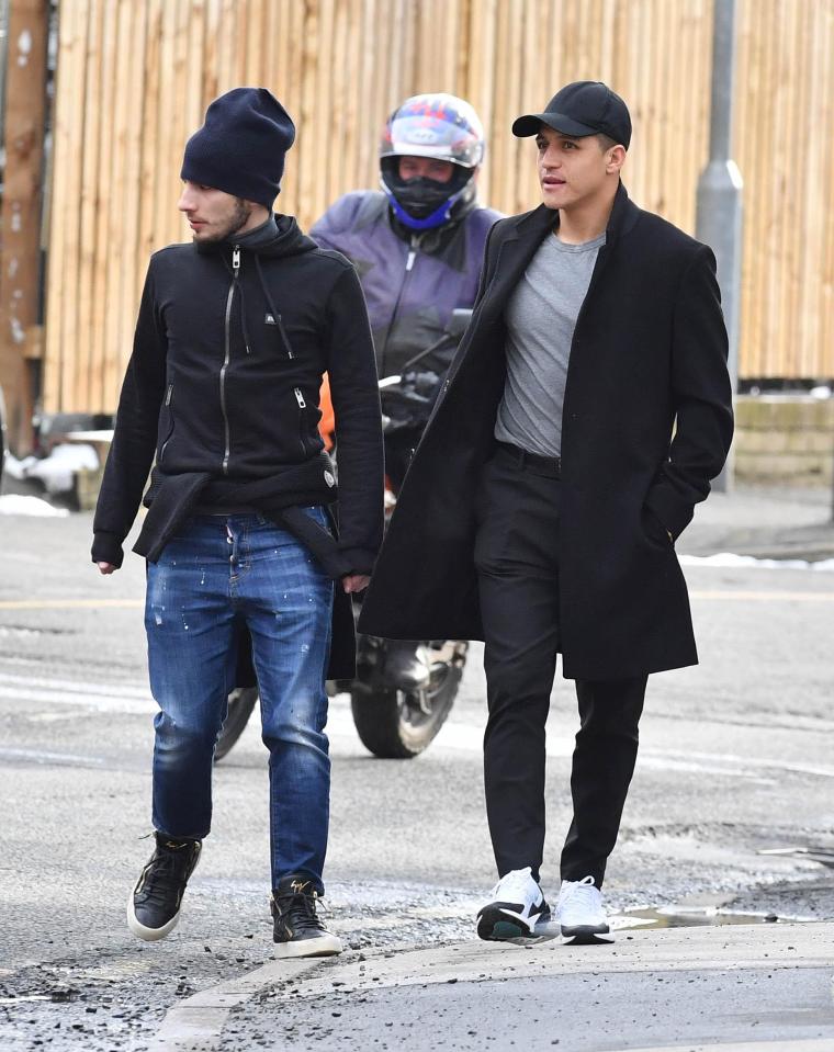 Manchester United striker Alex Sanchez surveys the damage to his car after a meal with friends