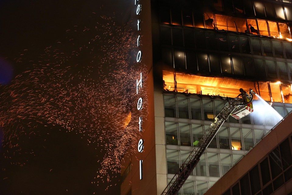 Witnesses said at least seven floors near the top of the tower appeared to be on fire