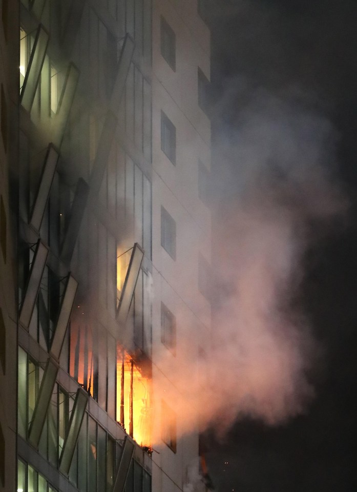 Windows exploded from the heat sending shards of glass and flaming debris crashing to the ground