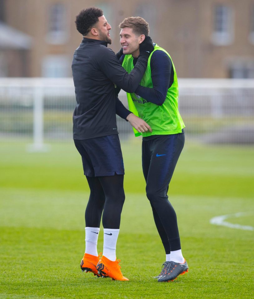 Kyle Walker and John Stones enjoy a private joke during the training session on Monday