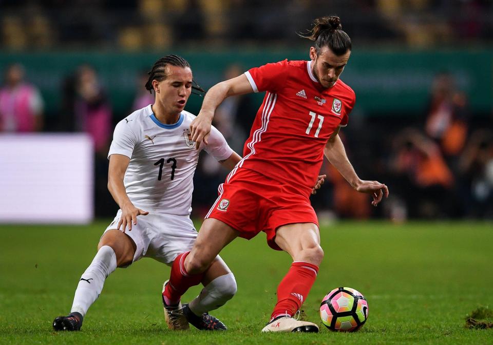  Gareth Bale is policed by Diego Laxalt during the China Cup final