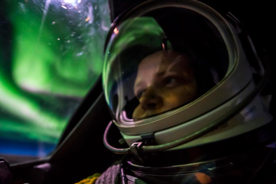 The 40 year old's once-in-a-lifetime shots include an amazing selfie, where the green natural light can be seen reflecting on the pilot's helmet 