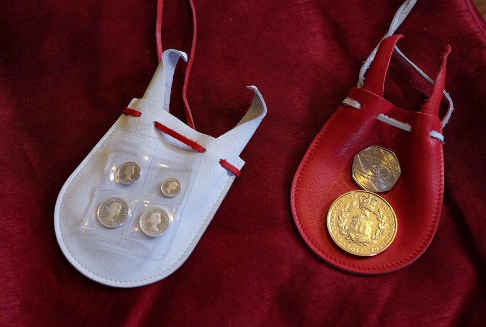  Each pensioner gets two leather purses filled with coins: silver Maundy money in the white and £5.50 in the red