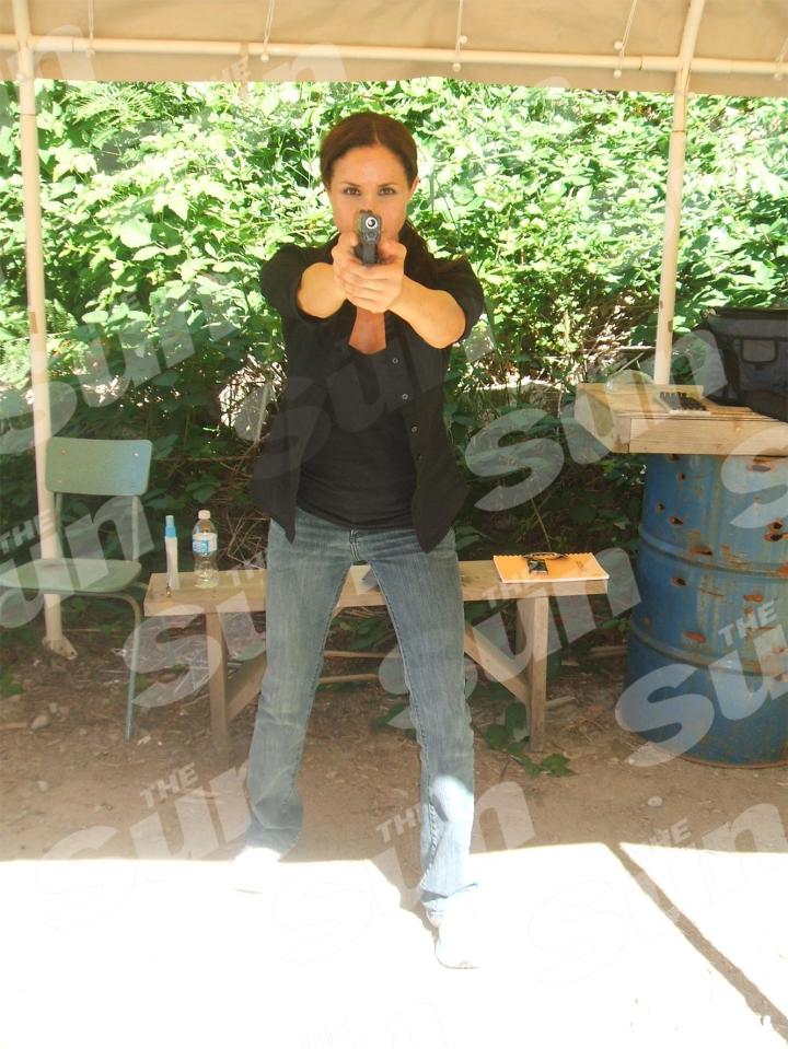 Meghan Markle points a gun to the camera as she underwent a one-day training session in 2009 for prepare for TV cop roles