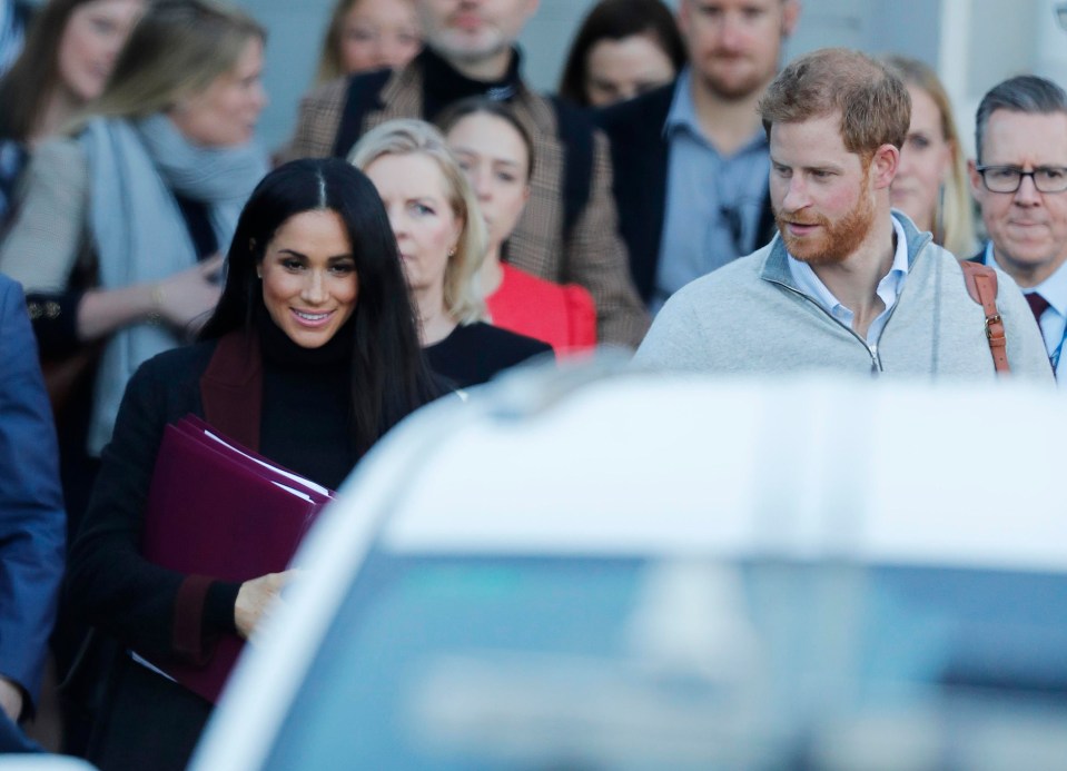 Meghan had fans guessing that she was pregnant when she appeared in Sydney carrying this purple folder