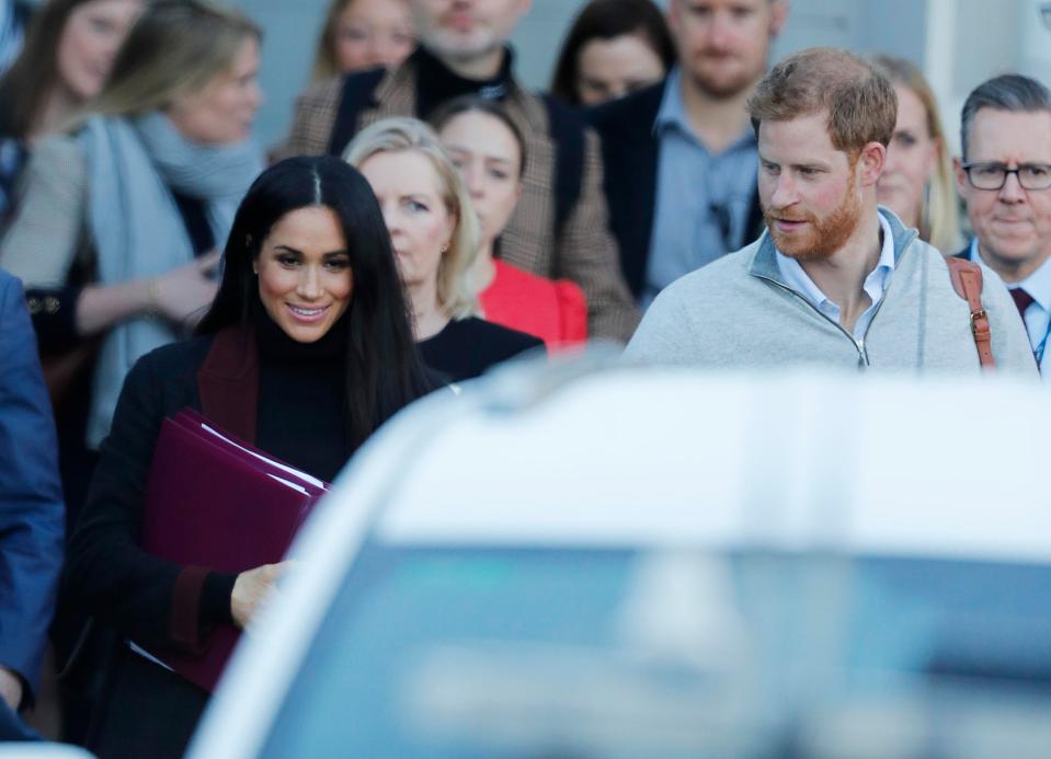  Meghan had fans guessing that she was pregnant when she appeared in Sydney carrying this purple folder