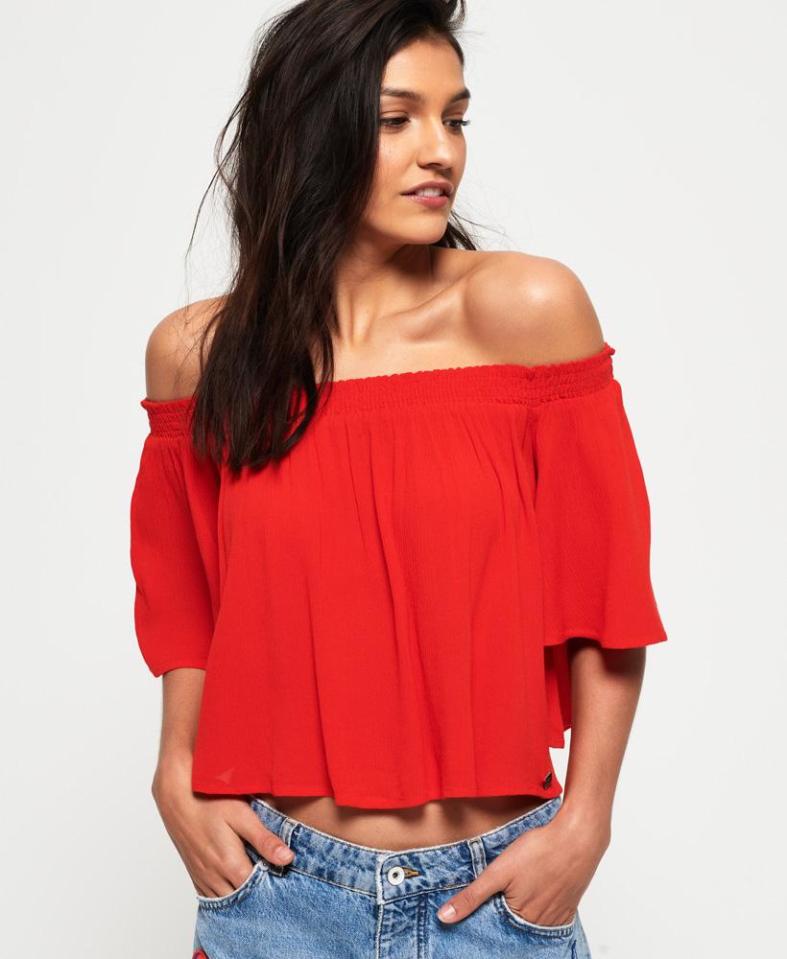  Lightweight, blouse style top with an off the shoulder and cropped design