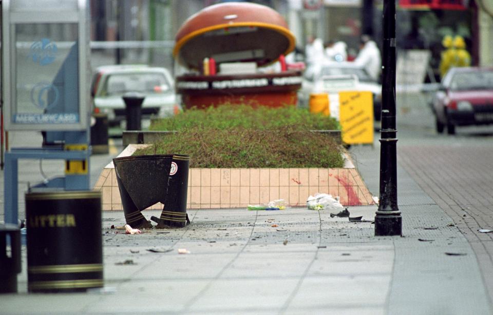  Debris and blood litter the scene outside the boots store in Warrington after a bomb exploded in a litter bin