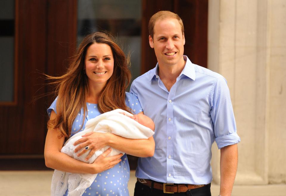  The Duke and Duchess of Cambridge holding their first child, Prince George, outside St Mary's Hospital