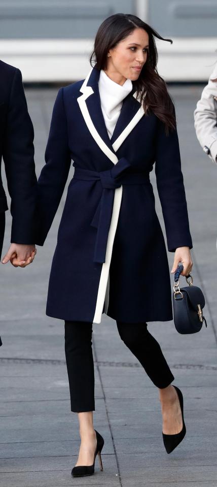  Meghan looks refined and polished in a chic navy and cream belted coat for her Birmingham Visit, March 2018