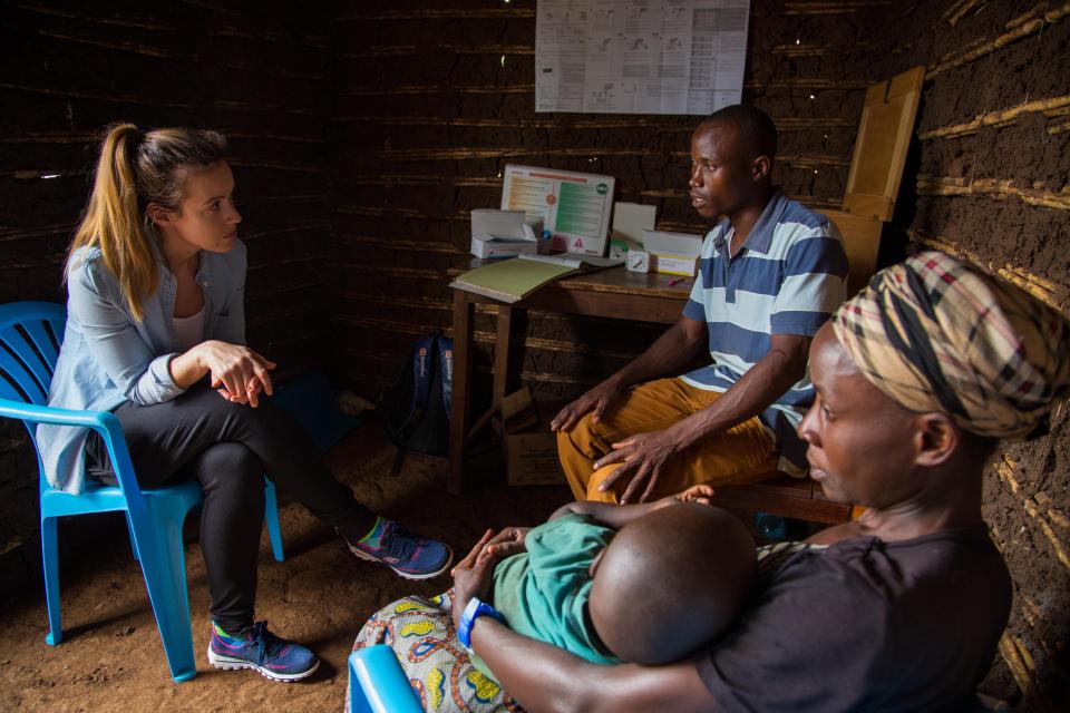  Charlie, with Pharaoh Kasyonga, talk to a local mum in a mud hut