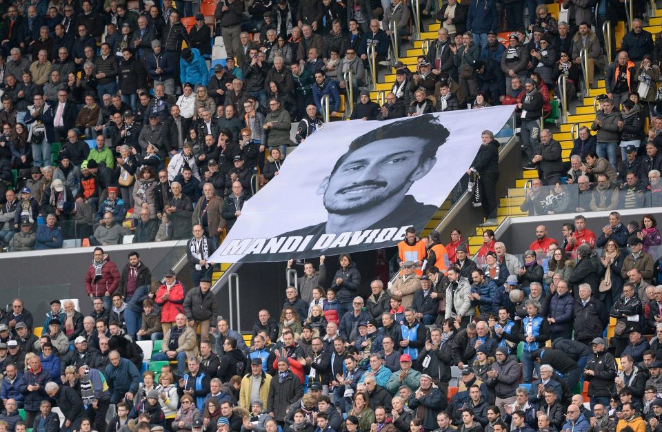 Fans hold aloft a banner bearing Davide Astori's face at Udinese