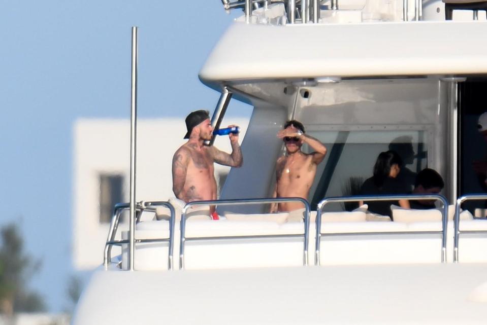  David Beckham relaxed with a beer aboard singer pal Marc Anthony's yacht over Easter where he was joined by his family