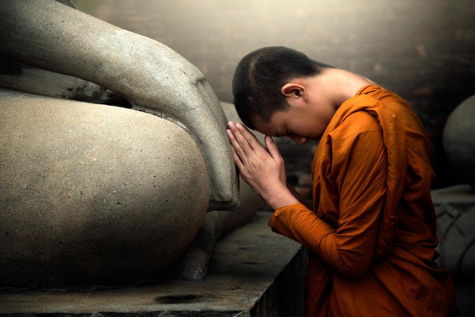 A Buddhist monk mediates in a temple 