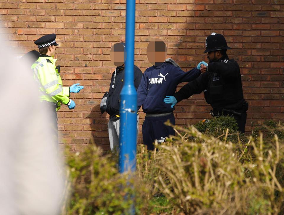  Cops search two youths at the scene of the killing in Walthamstow