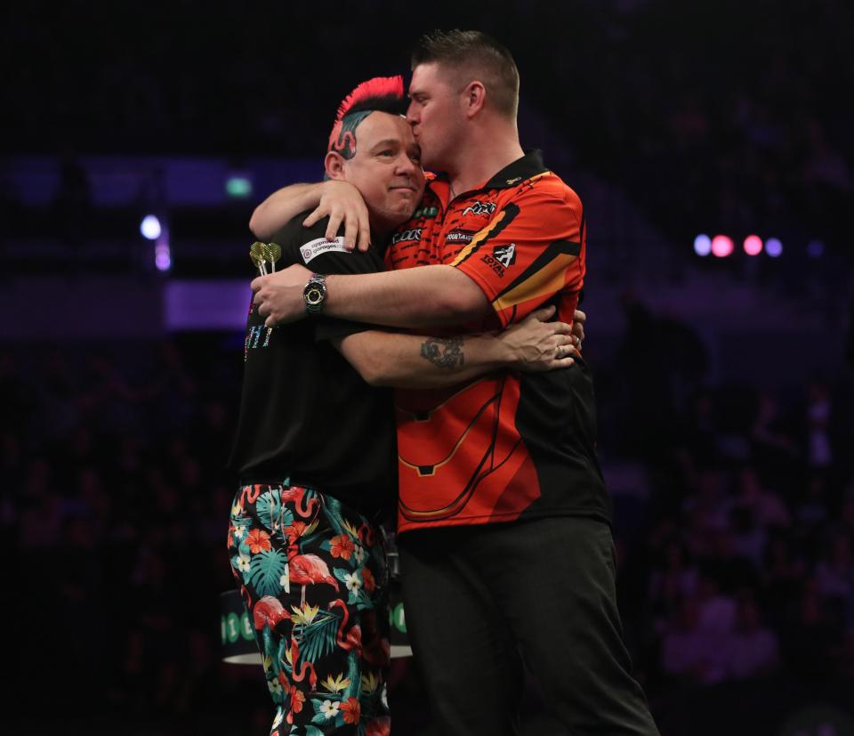 Darts ace Peter Wright and Daryl Gurney share an emotional moment