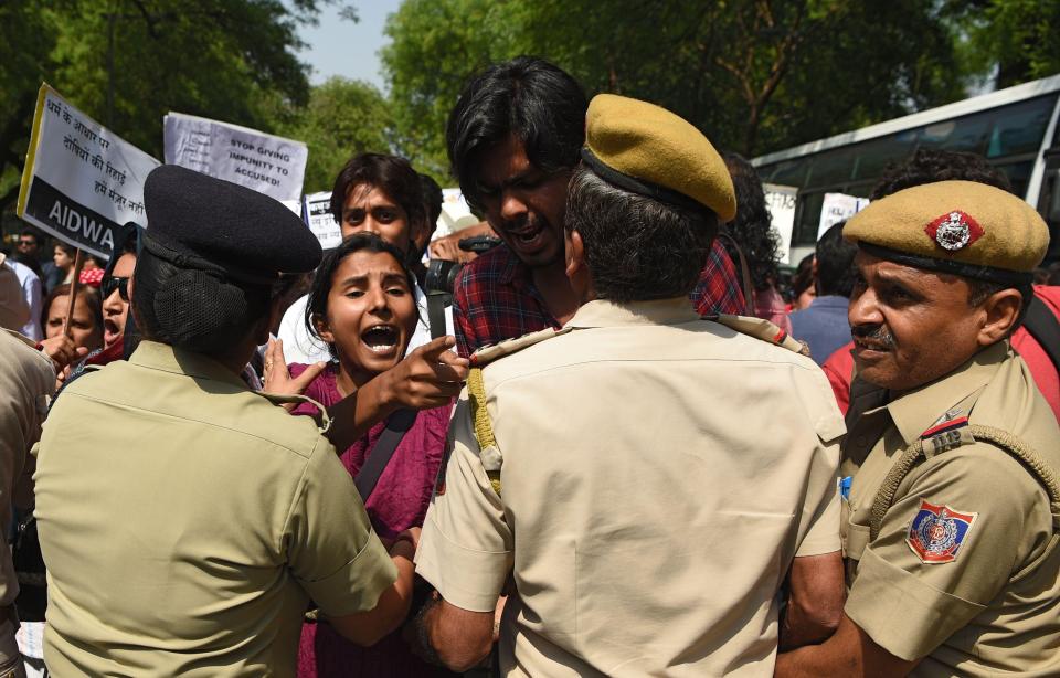  A woman clashes with police as a protest gathers momentum in the Indian capital Delhi