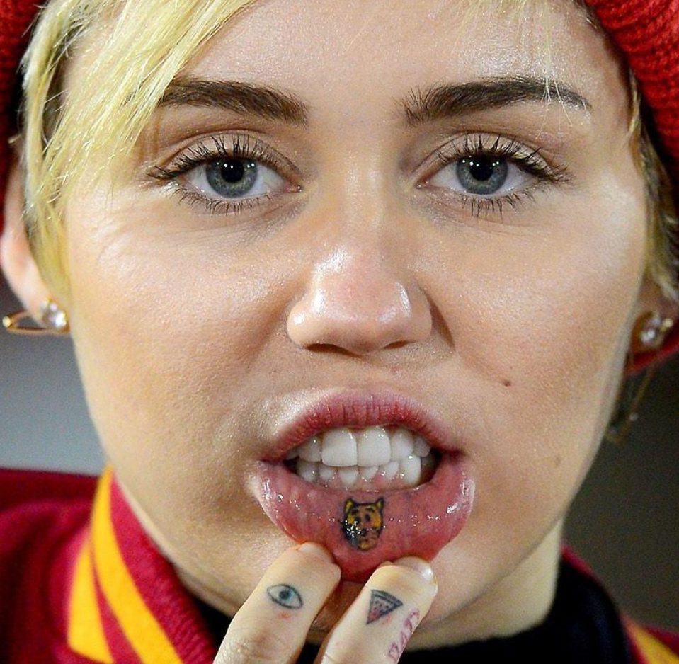  Miley's sad cat tattoo, eye and pizza slice are as memorable and weird as her performances