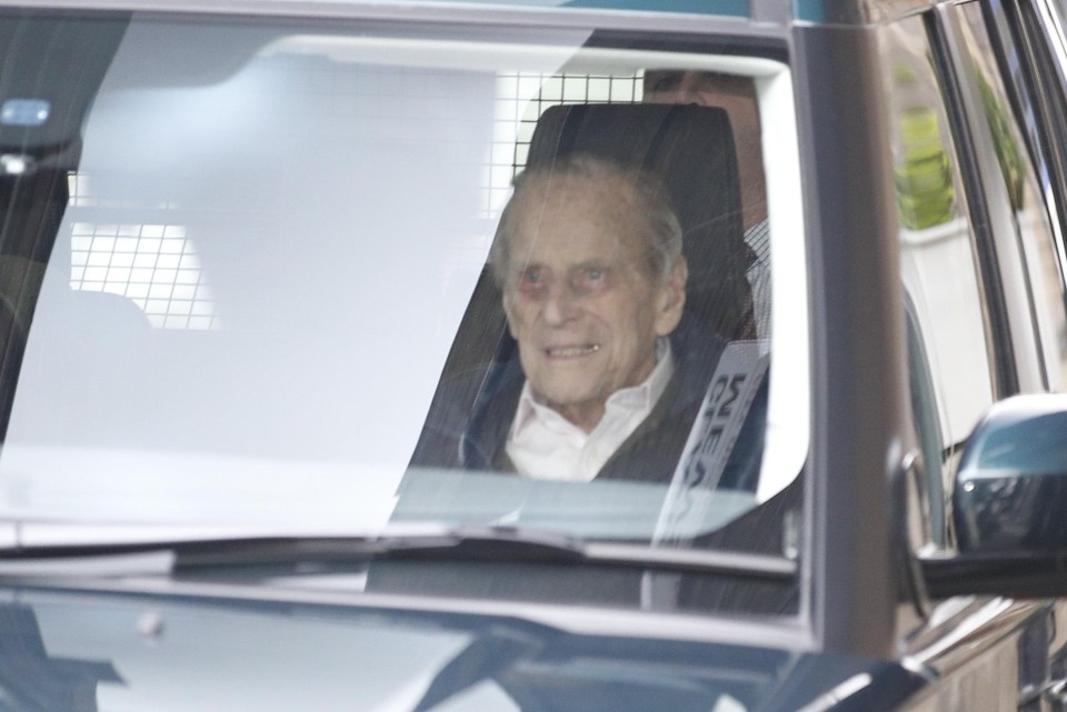 Prince Philip smiles as he leaves hospital following his hip op