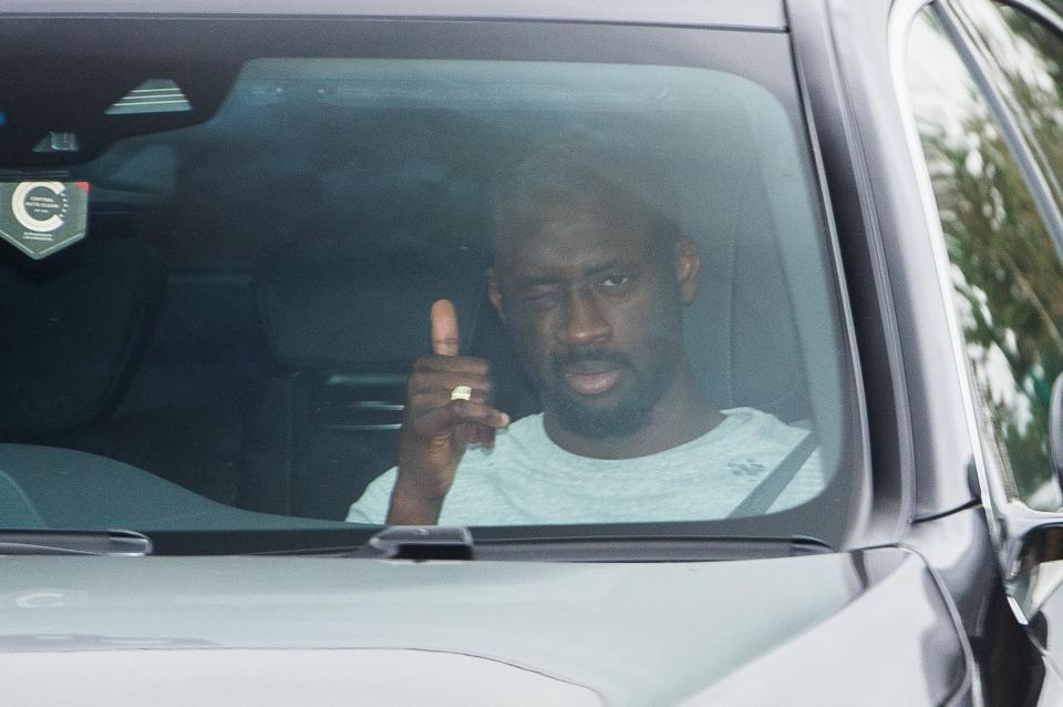 Yaya Toure gives a thumbs up as he arrived for Man City training today