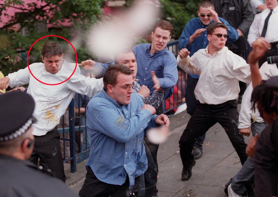  Luke Knight (ringed) runs for cover as he, David Norris and Neil and Jamie Acourt are pelted with eggs after leaving a Public Inquiry into police handling of the Stephen Lawrence murder case in London