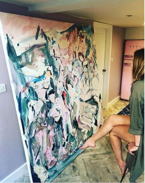  A recent pic shows her with this larger-than-life painting