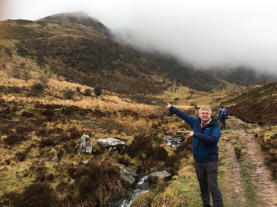  As we climb towards the snow-capped summit, the clouds surround us