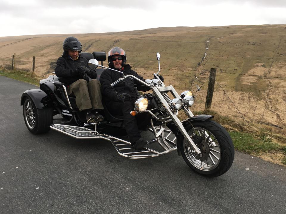  The black and chrome three-wheeler, with its Harley-style handlebars, has trekkers' heads turning