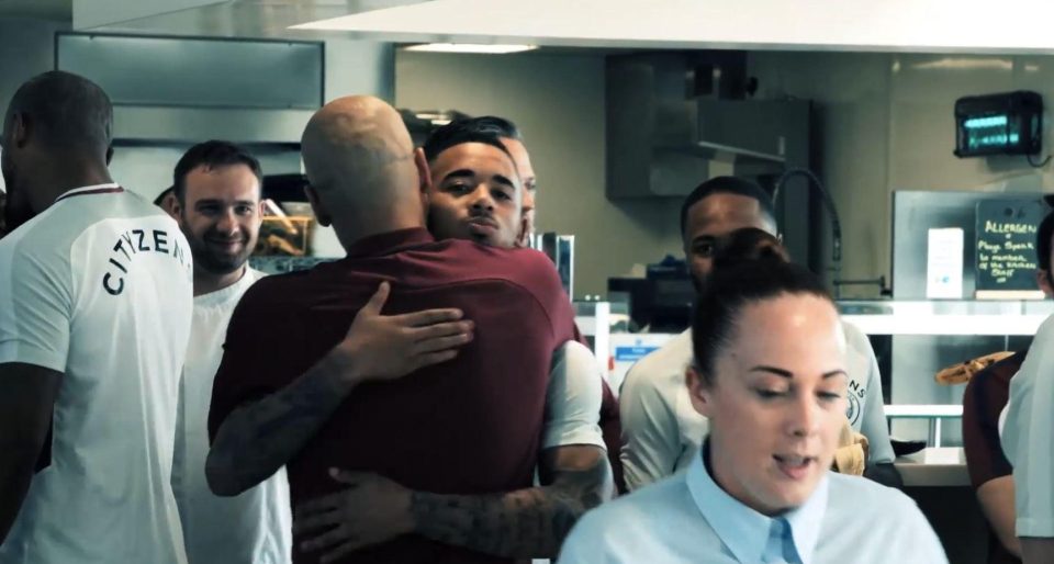 Pep Guardiola celebrates with players and staff at the City training ground