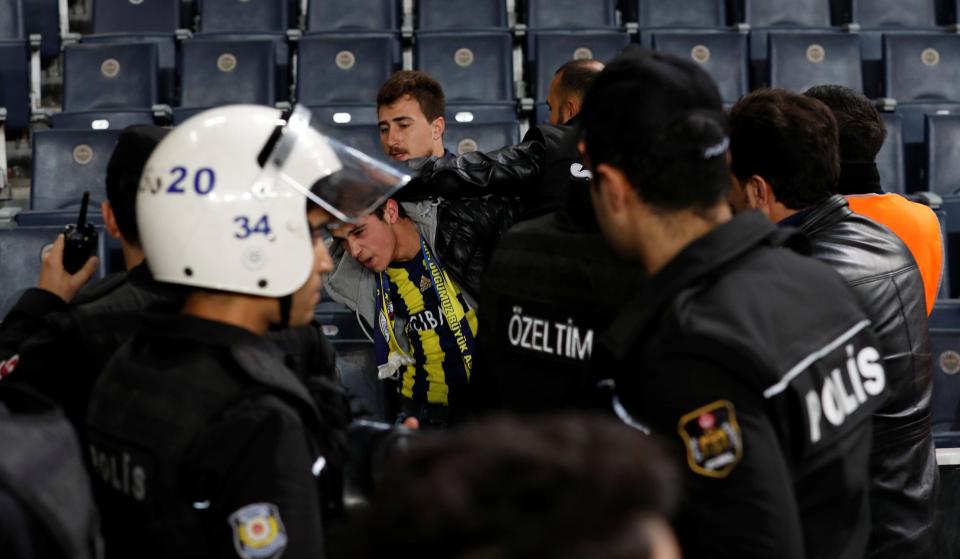  Fenerbahce fans are restrained by police during Besiktas clash