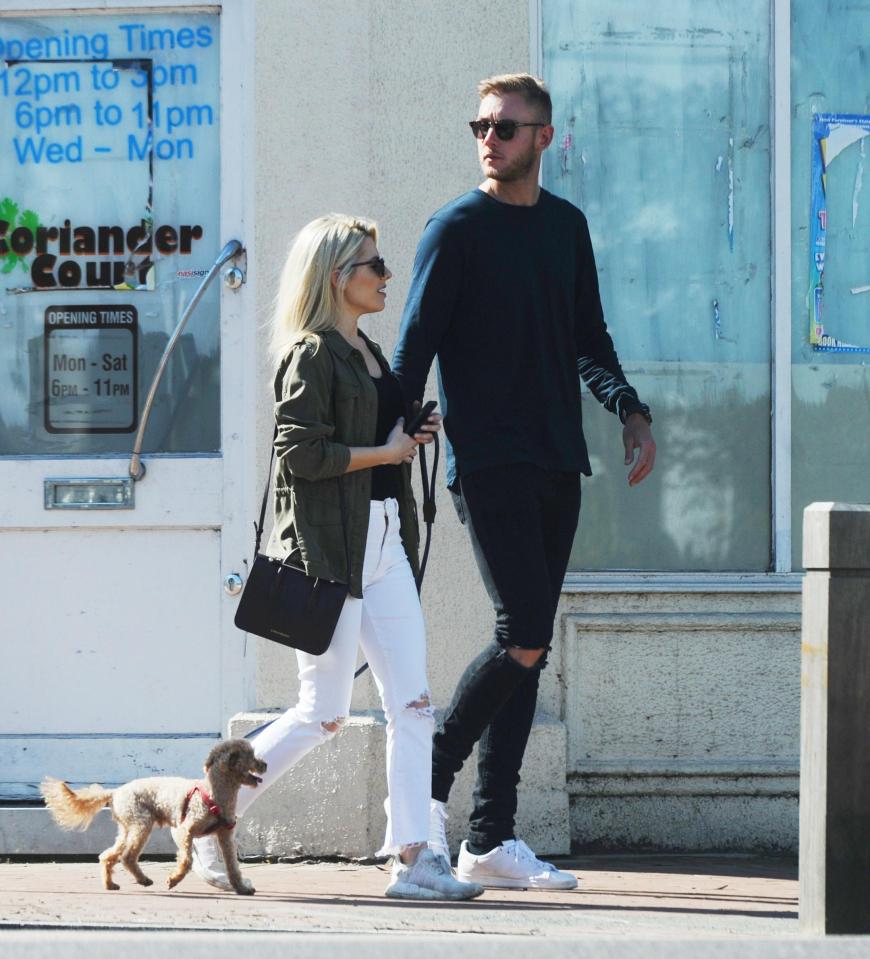 The couple look loved up on their romantic walk