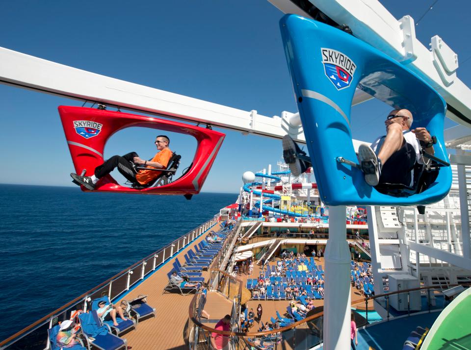  Guests aboard the Carnival Horizon pedal a SkyRide vehicle around much of the 133,500-ton cruise liner