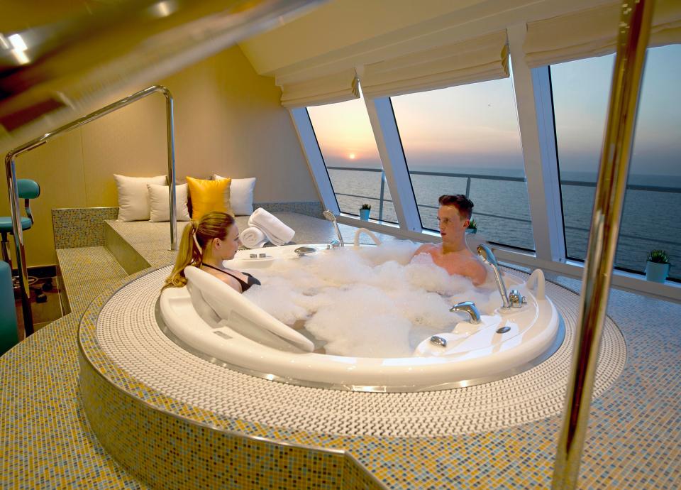  A couple aboard the Carnival Horizon enjoys the whirlpool in the ship's Cloud 9 Spa as the sun sets