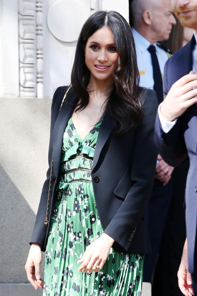  The sun was shining but Meghan covered up the pretty dress with a blazer