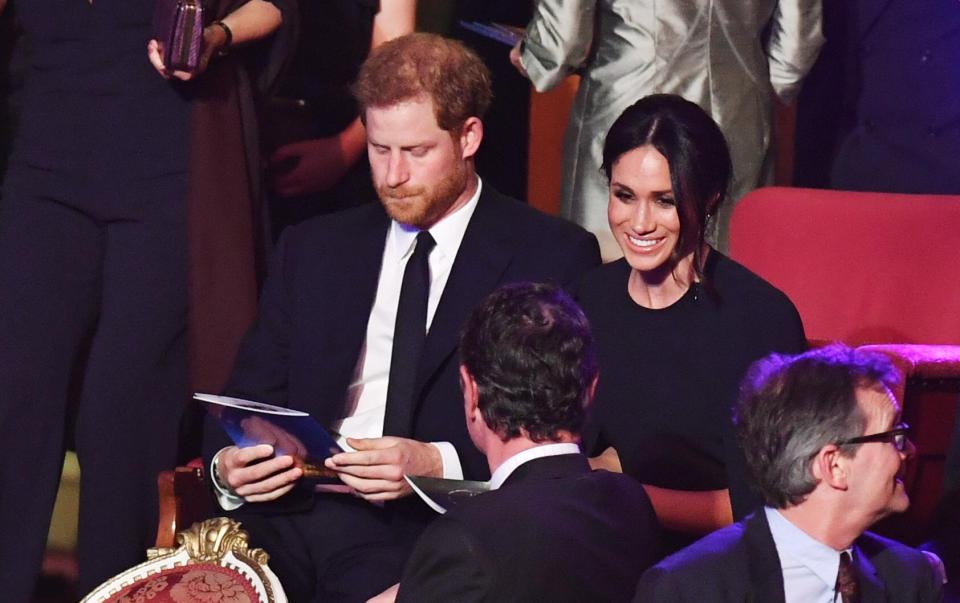  Meghan sat beside her husband-to-be at the bash