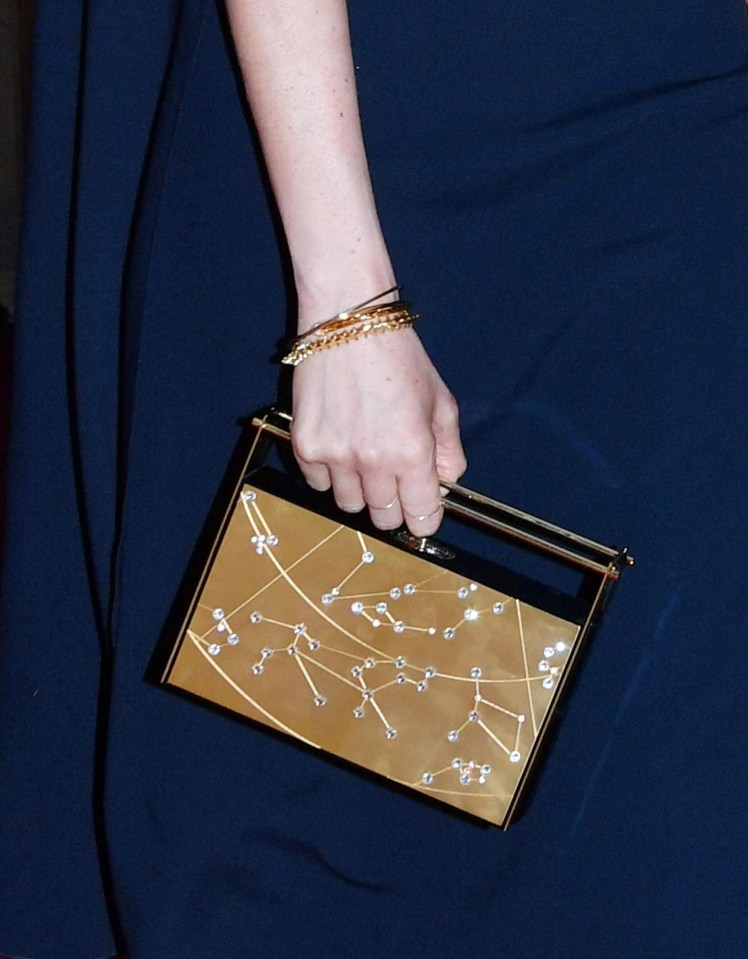 Meghan pared down her look with delicate gold accessories. This Naeem Khan clutch was the ultimate finishing touch