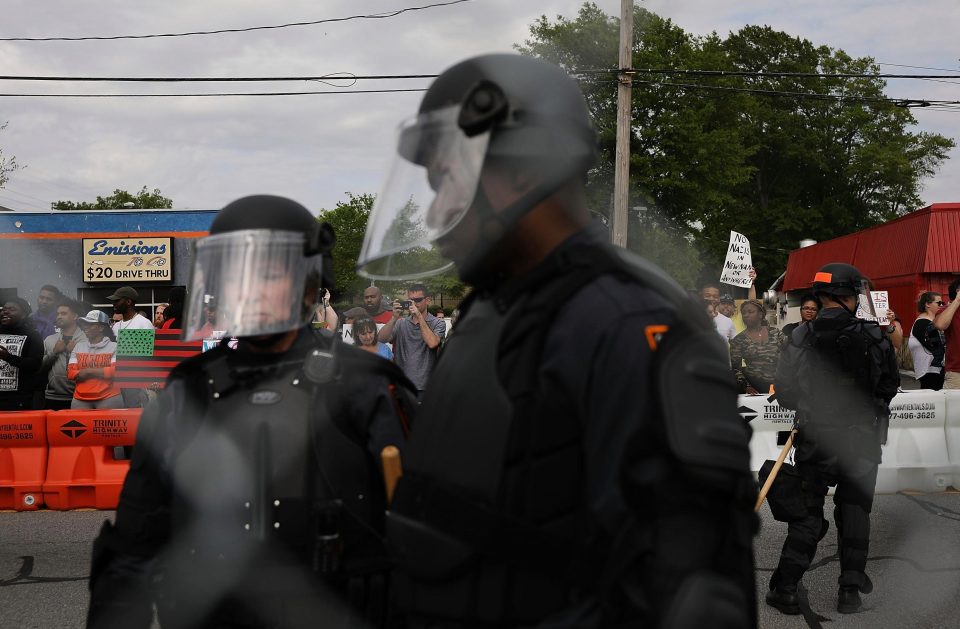  The armed cops held back a baying mob of anti-fascist protestors