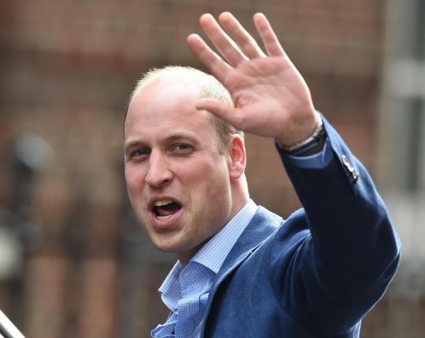 Prince William waved to waiting media as he left the hospital this afternoon