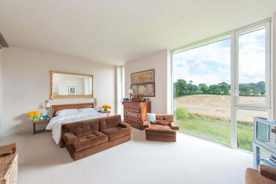  The property's floor-to-ceiling windows offer panoramic views of the Scottish countryside