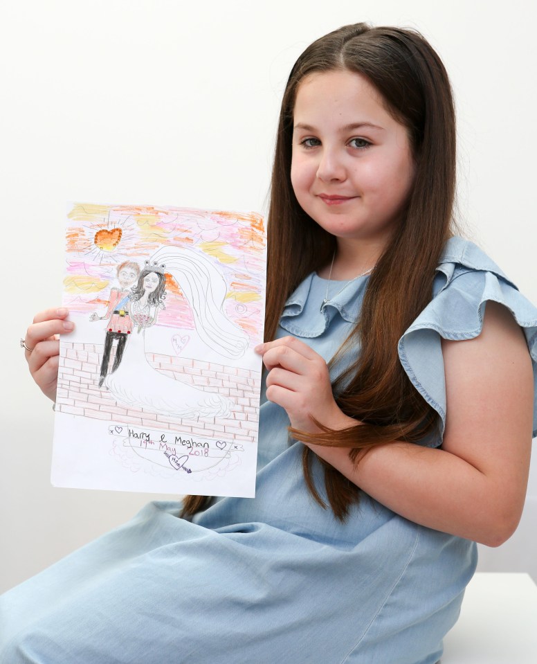 Lexie Errington, 10, shows off her winning commemorative tea towel design