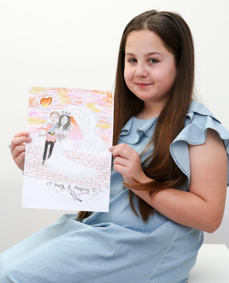  Lexie Errington, 10, shows off her winning commemorative tea towel design