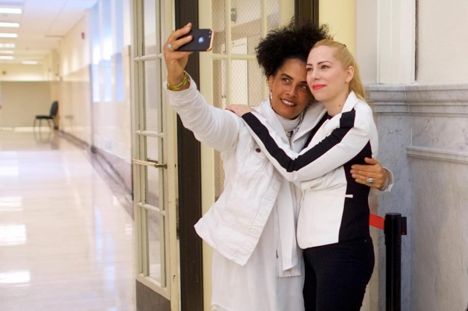 Accusers Lili Bernard and Caroline Heldman pose for a selfie outside Montgomery County Courthouse in Norristown, Pennsylvania