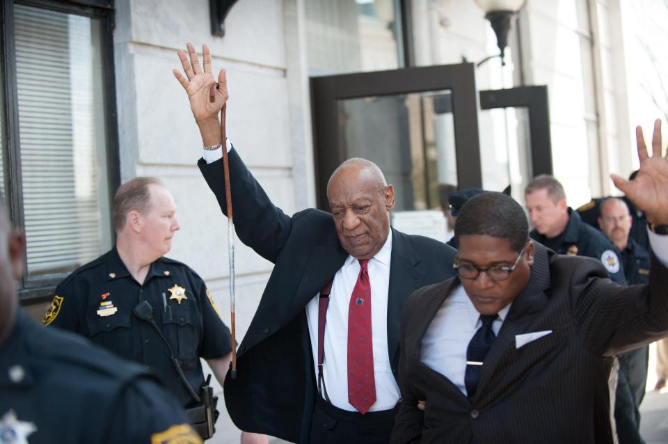 US comedian Bill Cosby leaves court with his hand raised after being guilty of sexual assaulting a woman 14 years ago