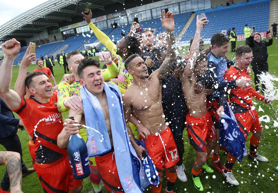  Wycombe Wanderers celebrate earning promotion to League One