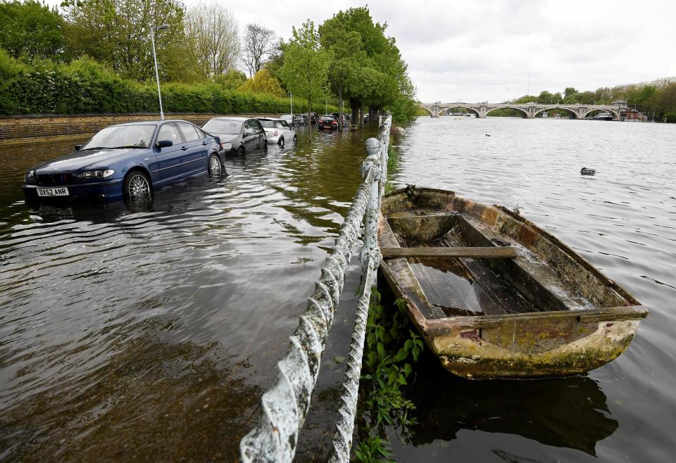  The Thames burst its banks in West London as rain lashed the UK today