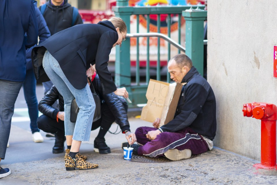 The couple stopped to give money to a homeless man