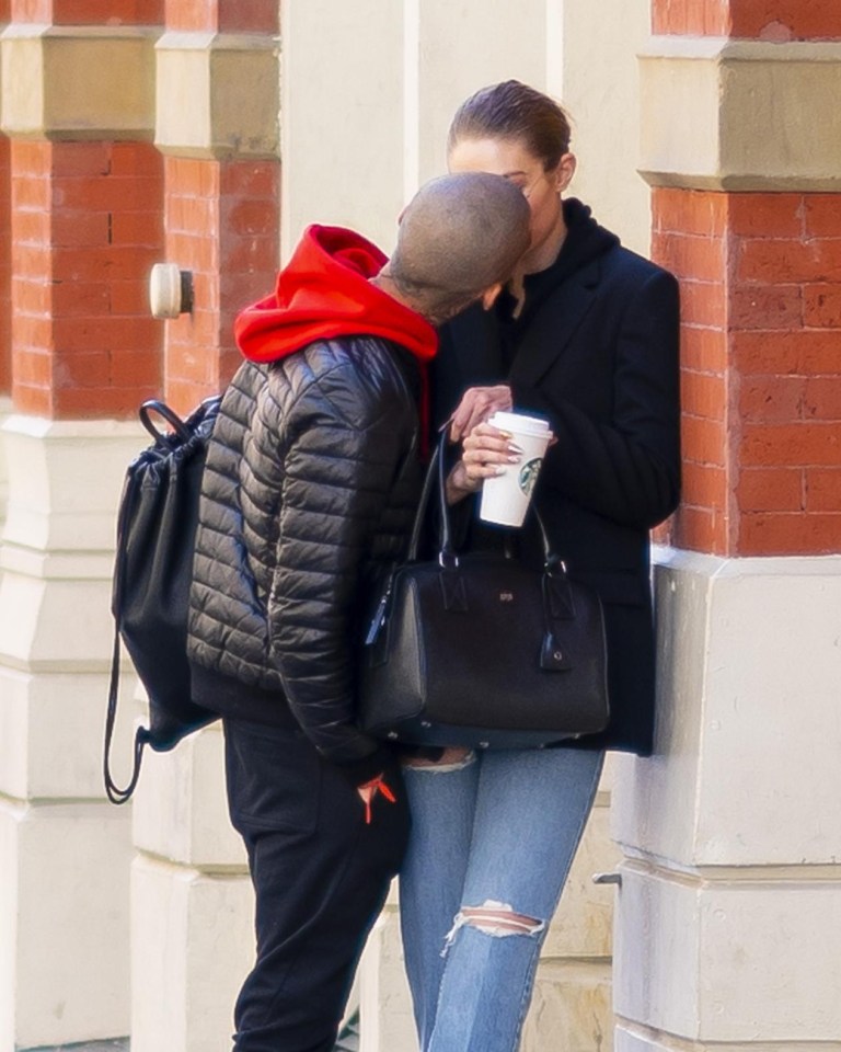 Zayn lent in for a kiss as they strolled in the city