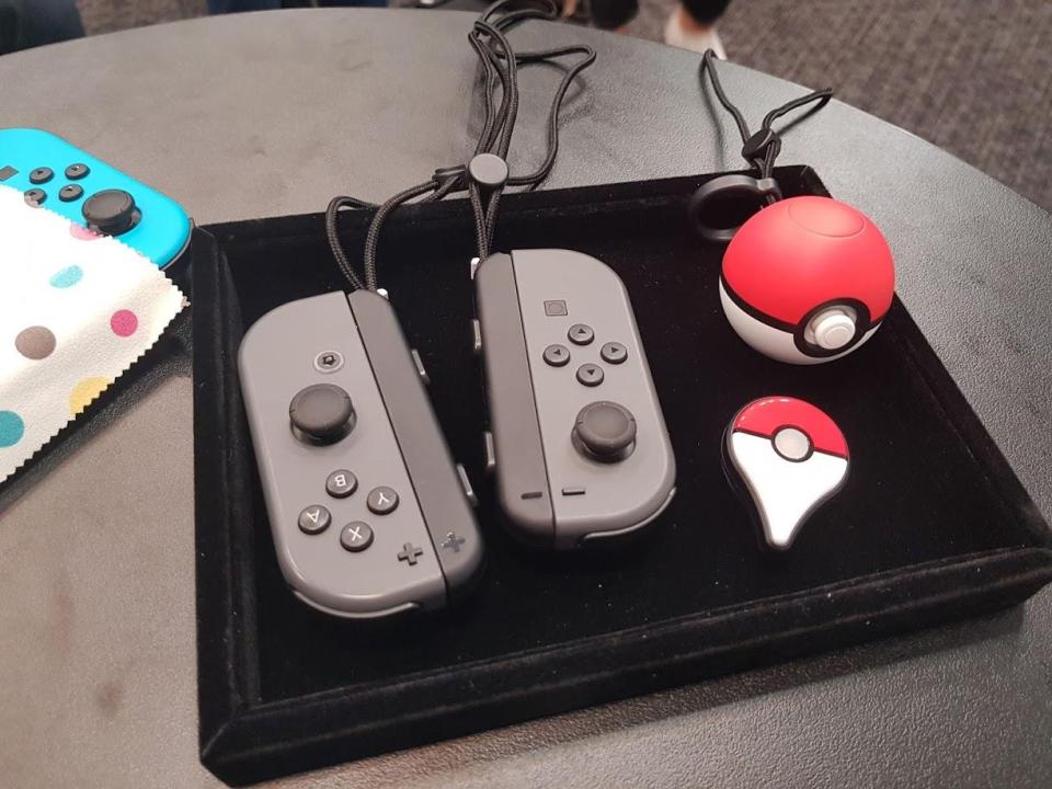  The Pokeball Plus controller alongside the traditional Nintendo Switch controllers